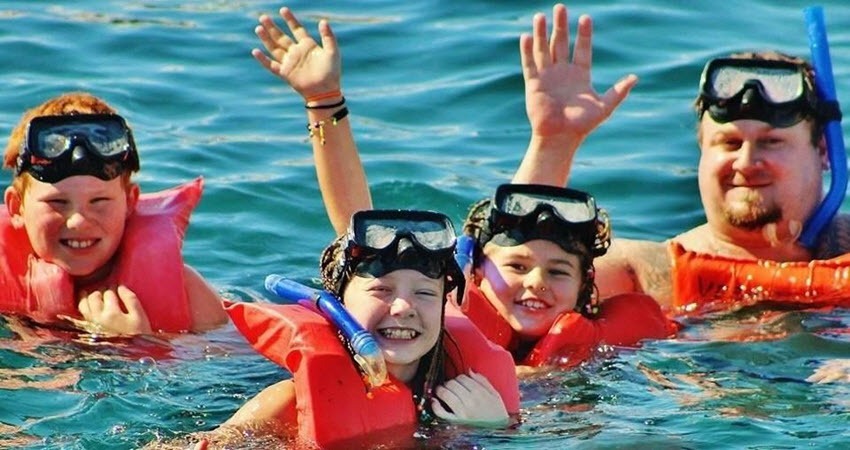 a group of people swimming in the water