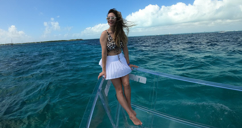 a woman standing next to a body of water